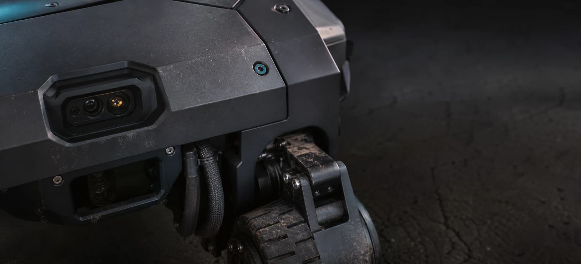 Close view of a rugged unmanned inspection robot with cameras, sensors, and articulated running gear